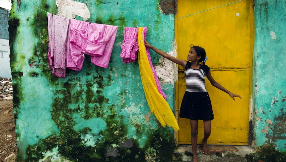 00159431-Lana Slezic-Panos-A young girl reaches to touch some bright pink clothing.jpg