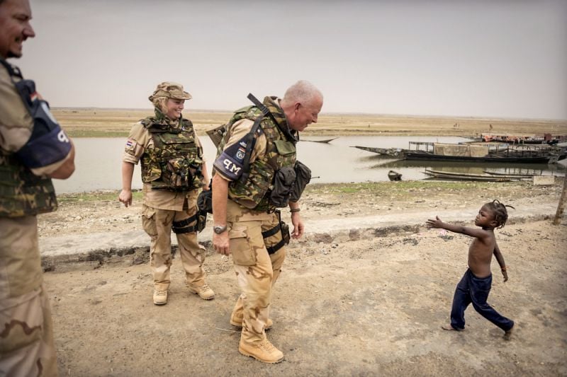 A young child who wants to shake hands