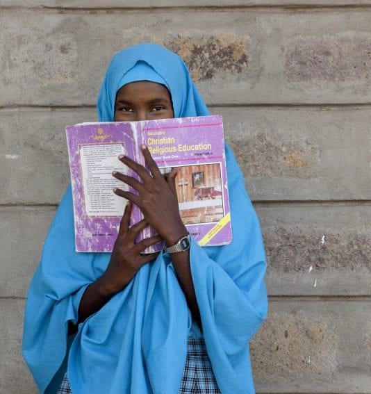 pupil holding a CRE book