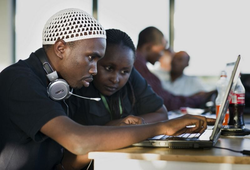 Young people use a computer at iHup