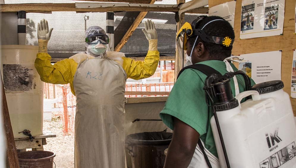 17 January 2019 - Beni, North Kivu region, Democratic Republic of Congo. Dr Ikomo get disinfected after having in contact with patients suffering from Ebola. Photo: World Bank / Vincent Tremeau