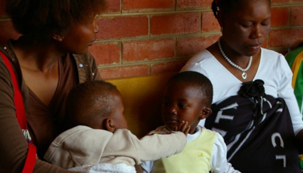 Mothers with babies waiting for HIV education session at a clinic in Lesotho, Southern Africa. By kommanderkat