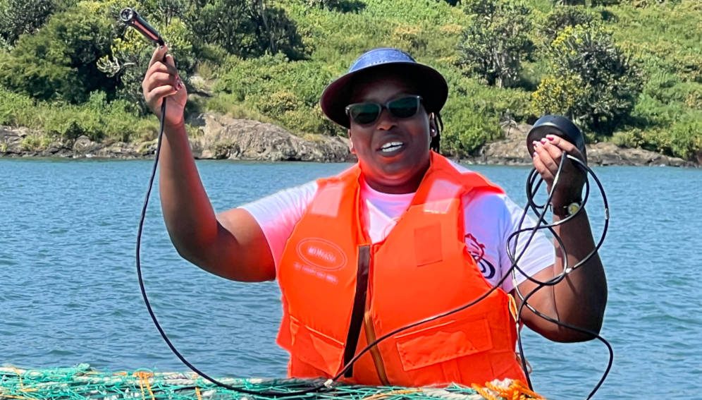 Mercy Chepkirui a project manager at Rio Fish showing off an IoT sensor they use to monitor tempreture and oxygen levels at a cage fish farm, Migori shores of Lake Victoria.