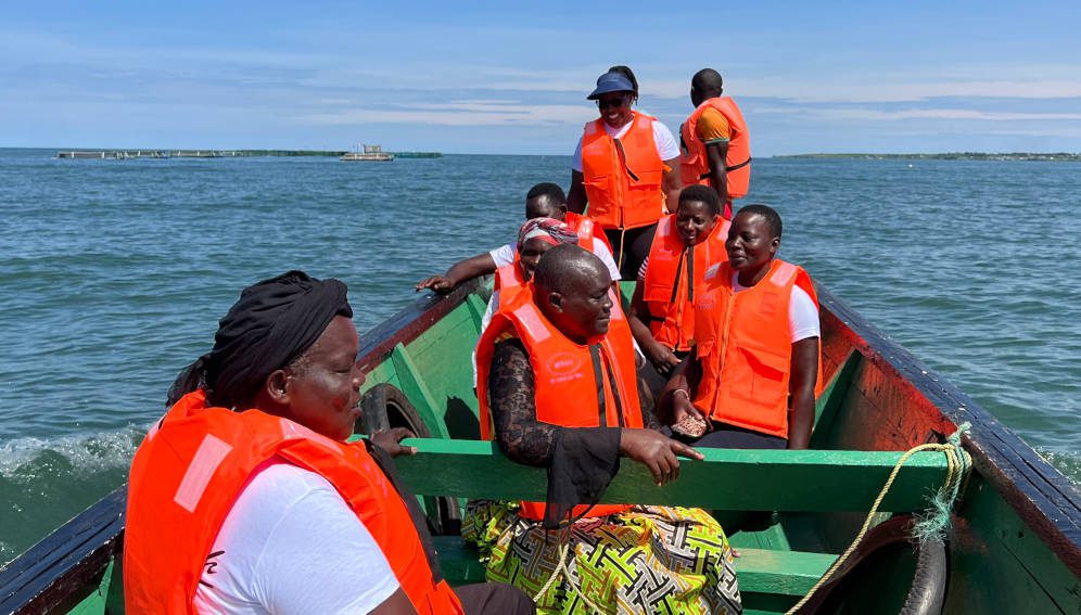 Women fish farmers on a canoe going to check on their fish cages near Rasira beach Migoro, Lake Victoria