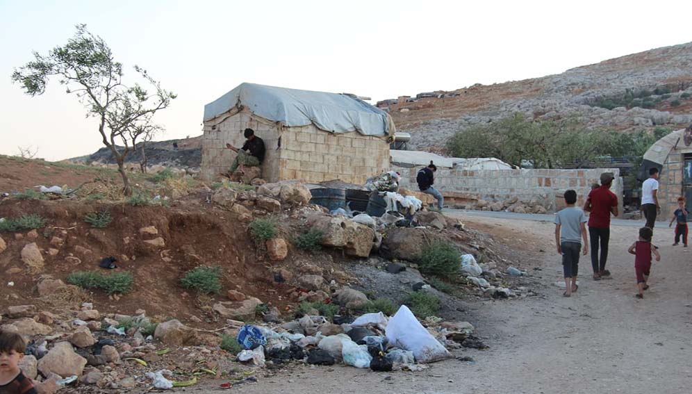Rubbish piles up at a makeshift camp for displaced people in Idlib, northern Syria after a USAID-funded charity stopped collecting waste. Photo courtesy of Hussein Al-Nahlawi | Story: loss of USAID funding is putting millions of lives at risk around the world