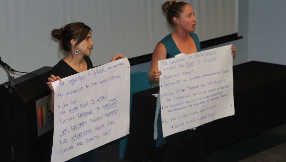 South African researchers, Dr. Amber Abrams and Dr. Anna James educate the public on the human right to access Water and Sanitation . Photo by: Neal Schachat