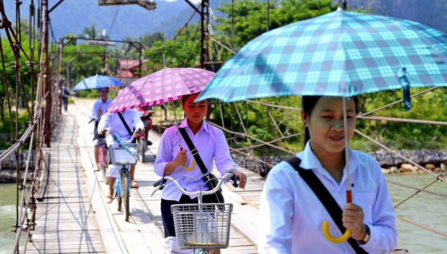 Laos women with umbrellas
