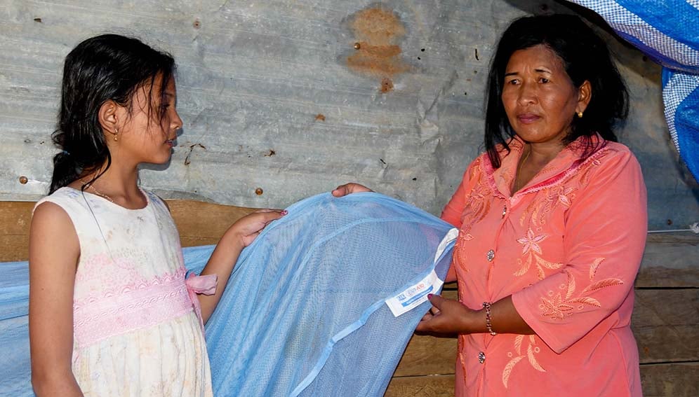Mother and daughter with a new mosquito net provided by USAI in 2015 in Battambang province, Cambodia