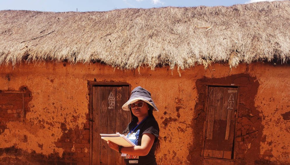 Adelaide Miarinjara checking on the list of households she is going to visit for interviews.