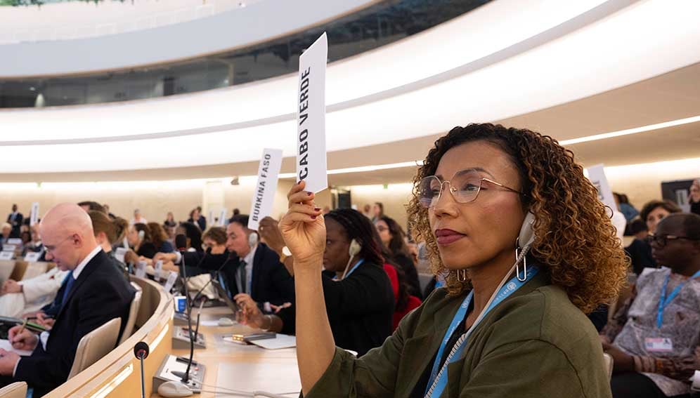 A representative of Cape Verde Islands raises her hand in Committee A during the Seventy-eighth World Health Assembly.
