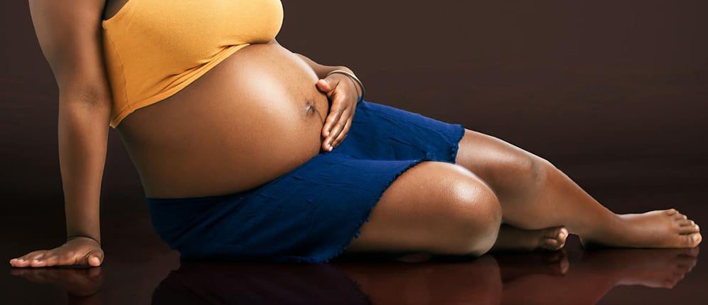 Photo by Lucretius Mooka: https://www.pexels.com/photo/pregnant-woman-sitting-on-the-floor-13428432/