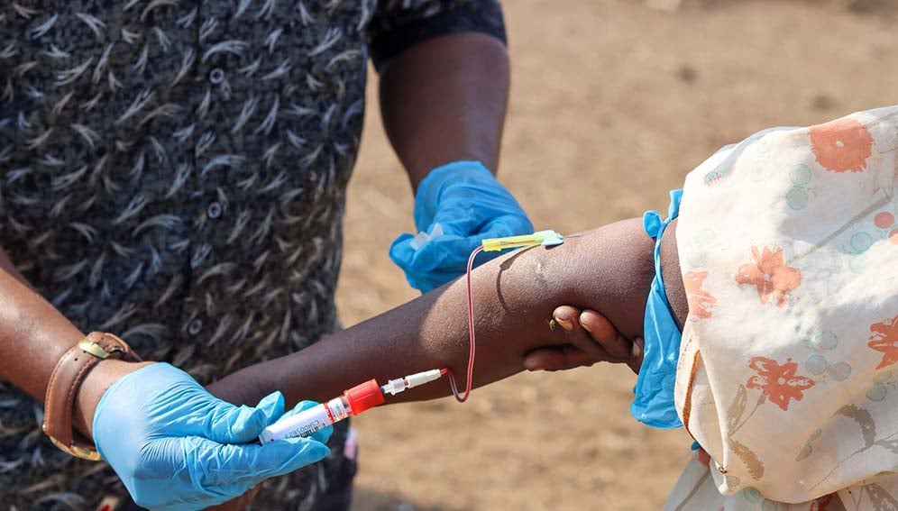 RVF_Bloodsampling2_MAIN A veterinarian taking a blood sample from a pastoralist in Isiolo, Kenya during a study to determine the prevalence of Rift Valley fever. Photo credit: ILRI/Geoffrey Njenga