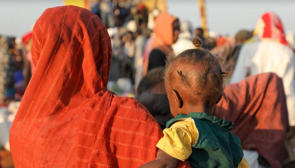 Families arrive at a transit centre in Renk, South Sudan, on 18 December after fleeing escalating violence in Sudan. © UNHCR/Reason Moses Runyanga