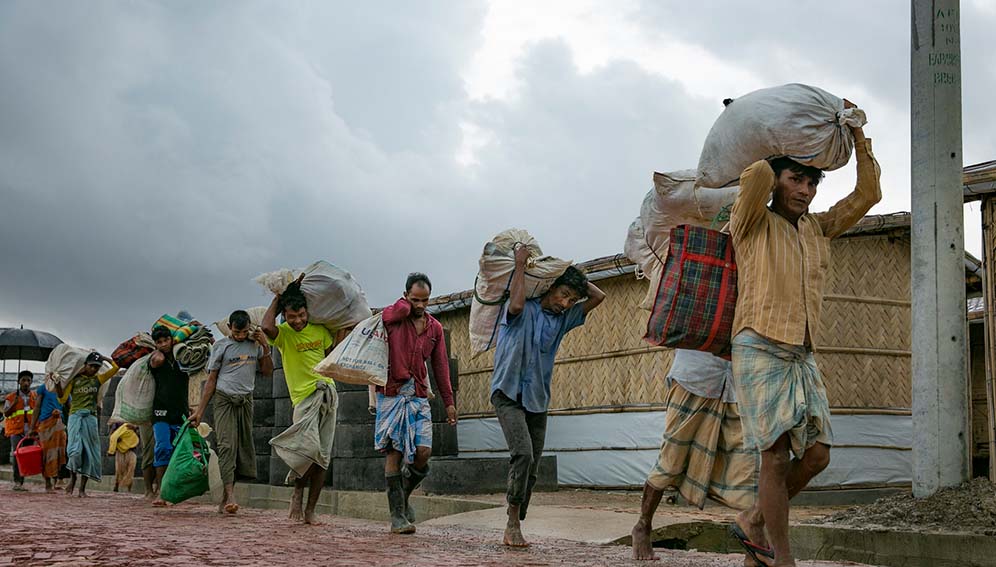 Rohingya refugees relocating because of flooding and landslides in the Balukhali Rohingya refugee camp in Cox's Bazar, Bangladesh in 2019. Photo: UN Women/Allison Joyce