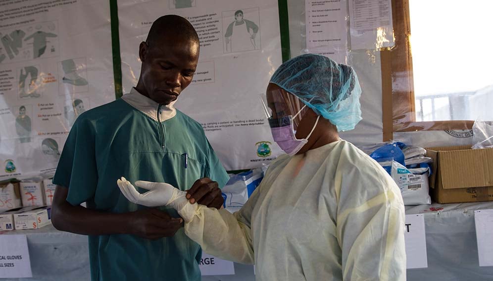 Health personnel dressing up in personal protective equipment (PPE).