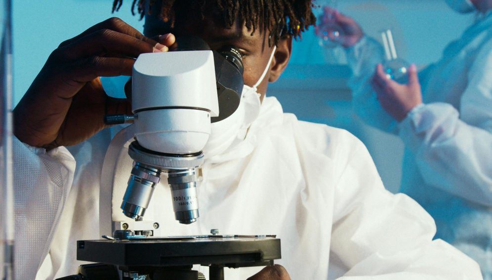 A Man Looking Through the Microscope (Pexels free photo)