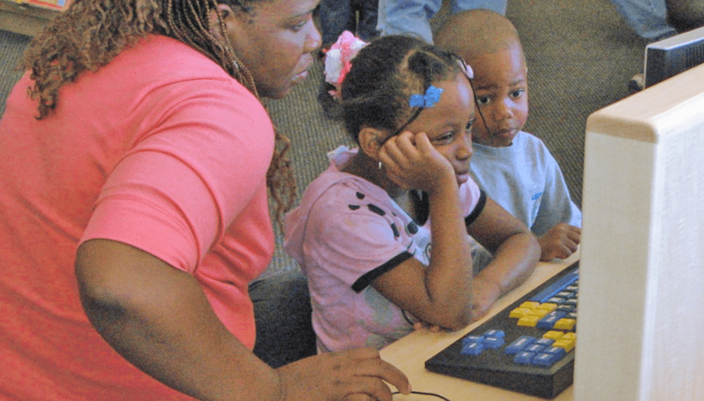 woman, boy, and girl on children's computer - San José Public Library. (CC BY-SA 2.0 DEED)