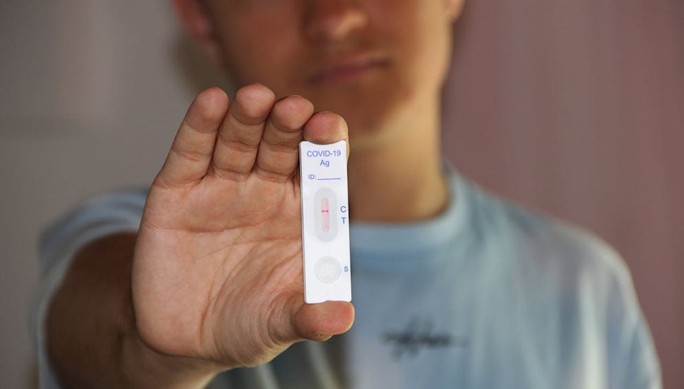 A Man Holding a Result of Antigen Test. Photo by Alex Koch: https://www.pexels.com/photo/a-man-holding-a-result-of-antigen-test-8390202/